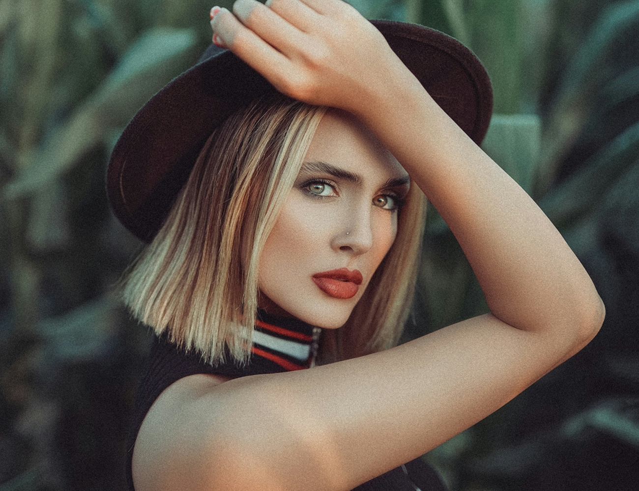 Photo of a blue hair girl holding her hat