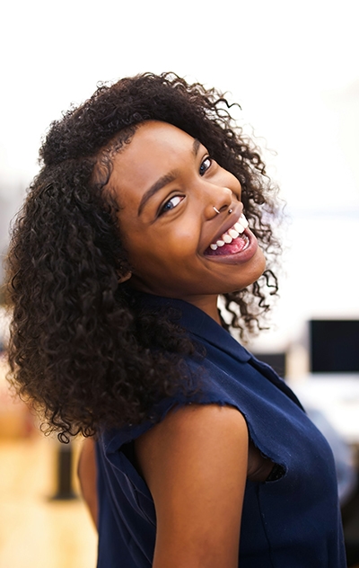 Black hair girl with curly hair smiling